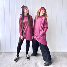 Ielādēt video galerijas pārlūkā, Women's A-line running skirt with an ombre (burgundy and pink) base and a Strelitzia floral pattern. The skirt has built-in black mid-length shorts with side pockets and a zipper pocket on the back.