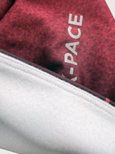 Ielādēt video galerijas pārlūkā, Women's A-line running skirt with an ombre (burgundy and pink) base and a Strelitzia floral pattern. The skirt has built-in black mid-length shorts with side pockets and a zipper pocket on the back.