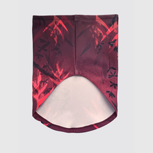 Ielādēt video galerijas pārlūkā, Women's A-line running skirt with an ombre (burgundy and pink) base and a Strelitzia floral pattern. The skirt has built-in black mid-length shorts with side pockets and a zipper pocket on the back.