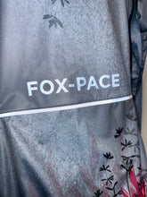 Ielādēt video galerijas pārlūkā, Women's A-line running skirt with an ombre (burgundy and pink) base and a Strelitzia floral pattern. The skirt has built-in black mid-length shorts with side pockets and a zipper pocket on the back.