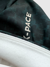 Ielādēt video galerijas pārlūkā, Women's A-line running skirt with an ombre (burgundy and pink) base and a Strelitzia floral pattern. The skirt has built-in black mid-length shorts with side pockets and a zipper pocket on the back.