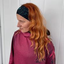 Ielādēt video galerijas pārlūkā, Women's A-line running skirt with an ombre (burgundy and pink) base and a Strelitzia floral pattern. The skirt has built-in black mid-length shorts with side pockets and a zipper pocket on the back.