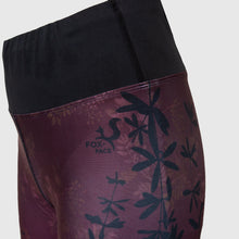 Ielādēt video galerijas pārlūkā, Women's A-line running skirt with an ombre (burgundy and pink) base and a Strelitzia floral pattern. The skirt has built-in black mid-length shorts with side pockets and a zipper pocket on the back.