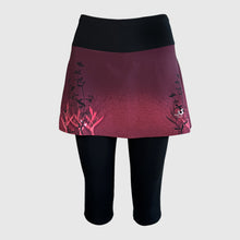 Ielādēt video galerijas pārlūkā, Women's A-line running skirt with an ombre (burgundy and pink) base and a Strelitzia floral pattern. The skirt has built-in black mid-length shorts with side pockets and a zipper pocket on the back.