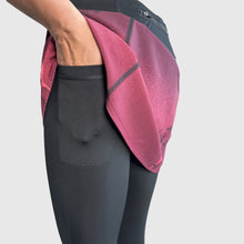Ielādēt video galerijas pārlūkā, Women's A-line running skirt with an ombre (burgundy and pink) base and a Strelitzia floral pattern. The skirt has built-in black mid-length shorts with side pockets and a zipper pocket on the back.