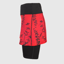 Ielādēt video galerijas pārlūkā, Women's A-line running skirt with an ombre (burgundy and pink) base and a Strelitzia floral pattern. The skirt has built-in black mid-length shorts with side pockets and a zipper pocket on the back.